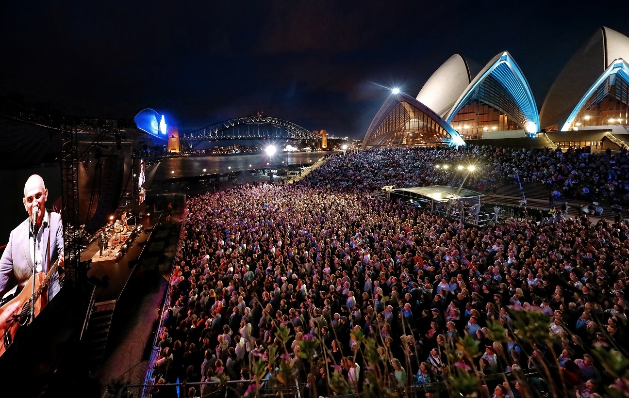 A crowd of people at the Paul Kelly's concert in the Forecourt.