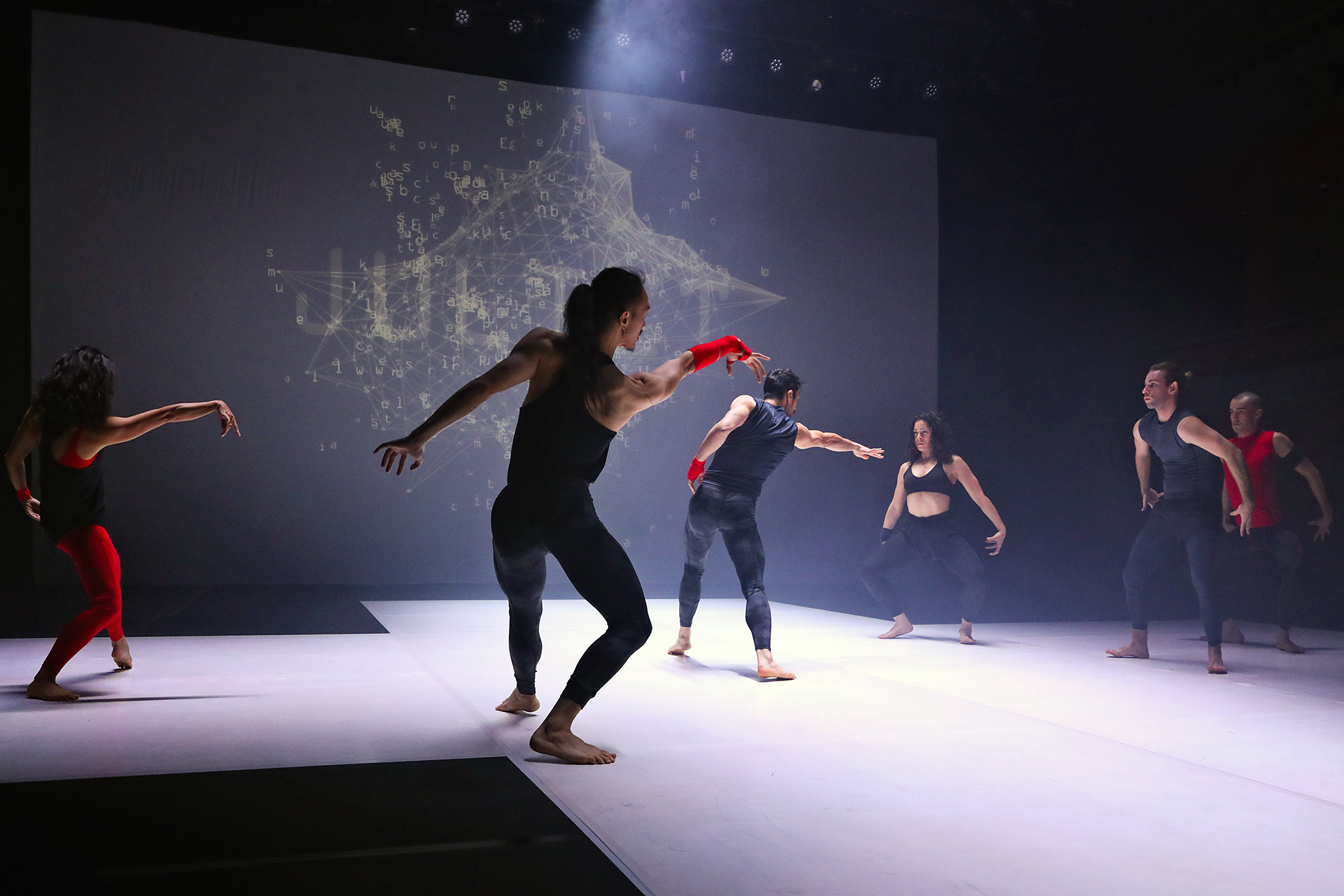 A group of six dancers performing on stage