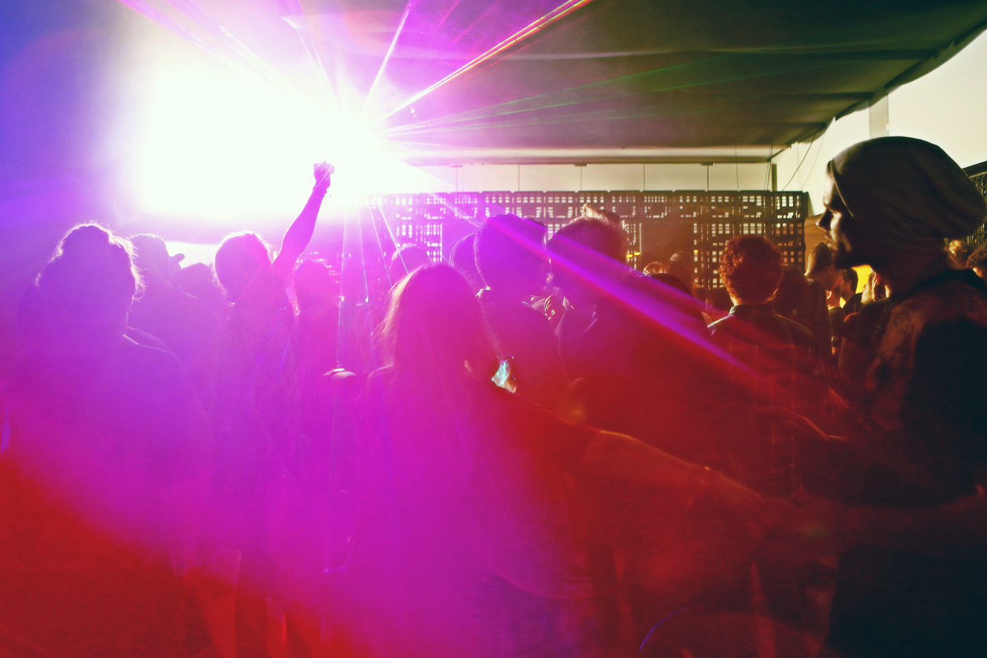 A lively audience in neon strobe lights.