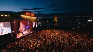 A crowd of people attending a musical concert.
