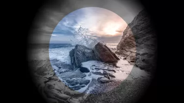 An image of a wave crashing against a rocky shore