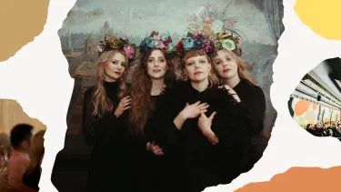 Four women in dark dresses stand closely, each wearing a floral crown.