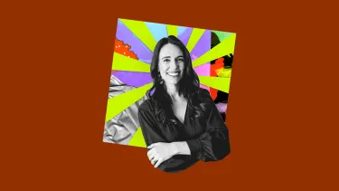 Black and white image of a smiling woman with crossed arms, set against a vibrant, multicolored background.