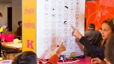 A kid getting a temporary tattoo from a stall.