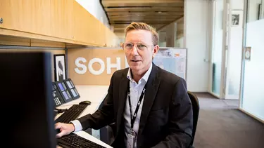 A man in a suit working in an office.