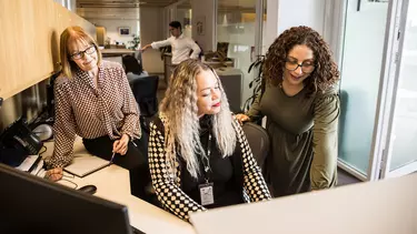 Three women in an office.