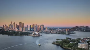 A long shot of Sydney opera house and Sydney CBD at sunset.