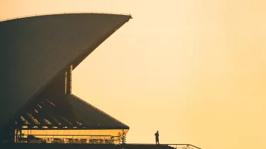 A sail of Sydney opera house at sunset.