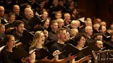 A choir singing with books in their hands.