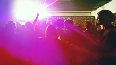 A lively audience in neon strobe lights.