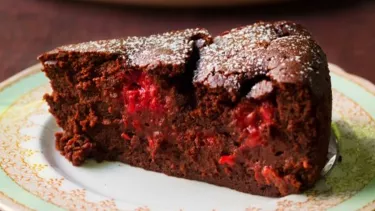 A slice of chocolate cake with a red center on a pkate.