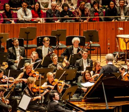 Lang Lang plays piano in front of the Sydney Symphony Orchestra in the Sydney Opera House Concert Hall