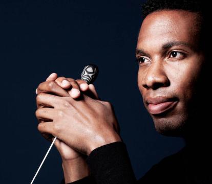 A close up of conductor Roderick Cox