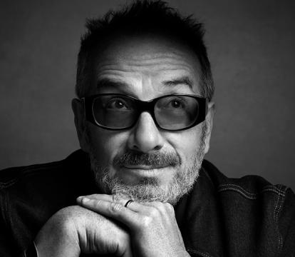 A man with short hairs and beard in a jacket.