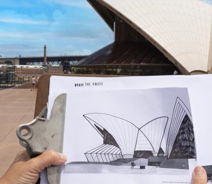 A hand drawn picture of the Sydney Opera House on a clipboard