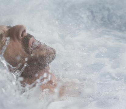 Man face up surrounded by water