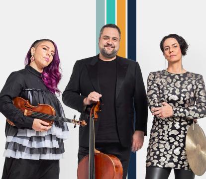 Two women and one man pose for a picture holding a violin, cello and cymbol.