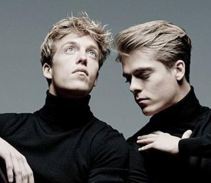 Lucas and Arthur Jussen stand next to each other in black shirts.