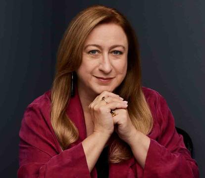 Simone Young wears a red shirt.