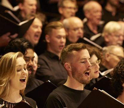 A choir singing with books in their hands.