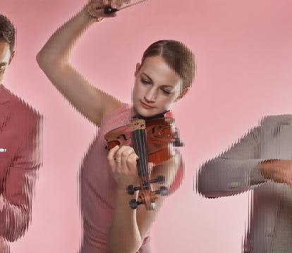 Three artists playing a violins and a tuba, against a pink background.
