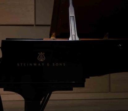 Yeol Eum Son plays the piano in a black dress.