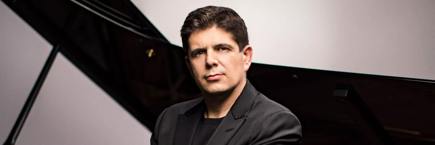 Pianist Javier Perianes sits in front of a grand piano