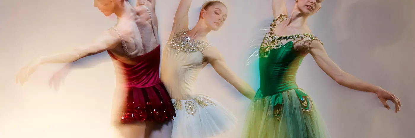 Three ballerinas doing ballet.