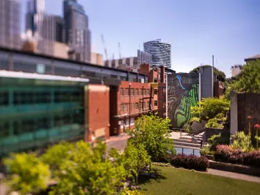 A huge building in front of a city skyline.